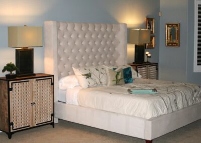A bed with an upholstered headboard.