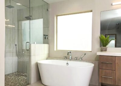 A modern bathroom with a glass shower and tub.