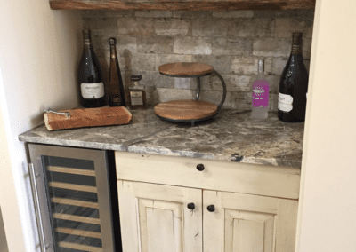 A kitchen with a wine rack and liquor bottles.